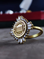 Load image into Gallery viewer, A beautifully designed women's university ring, crafted with gold plating for a refined and elegant look. This class ring is a perfect way to commemorate graduation or show school pride. Whether worn daily or saved for special occasions, this timeless piece serves as a lasting reminder of success, determination, and academic excellence.
