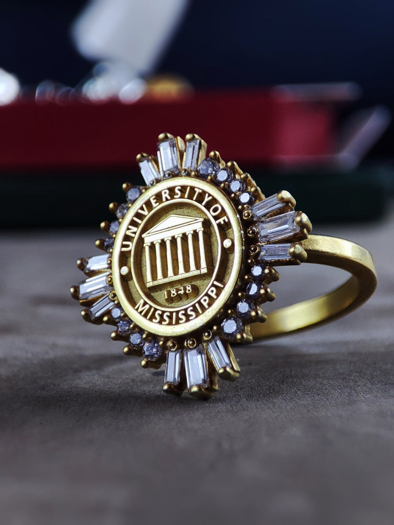 A minimal yet elegant university ring, crafted in gold plating for a sleek and polished finish. This timeless signet ring is perfect for graduates and alumni who want a stylish keepsake of their academic success. A great stacking ring or statement piece that makes a thoughtful and personal graduation gift.