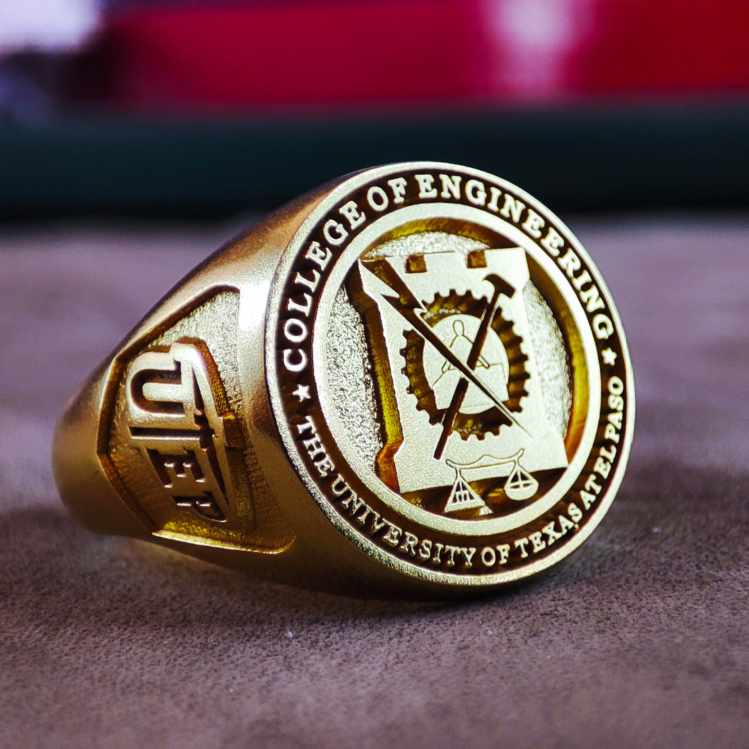 A sophisticated round university signet ring, crafted in vermeil gold for a timeless look. Designed for students and alumni, this personalized class ring is perfect for commemorating graduation. With its sleek and simple design, this piece is both elegant and durable, making it a cherished keepsake for years to come. A stylish yet meaningful gift for any academic milestone.