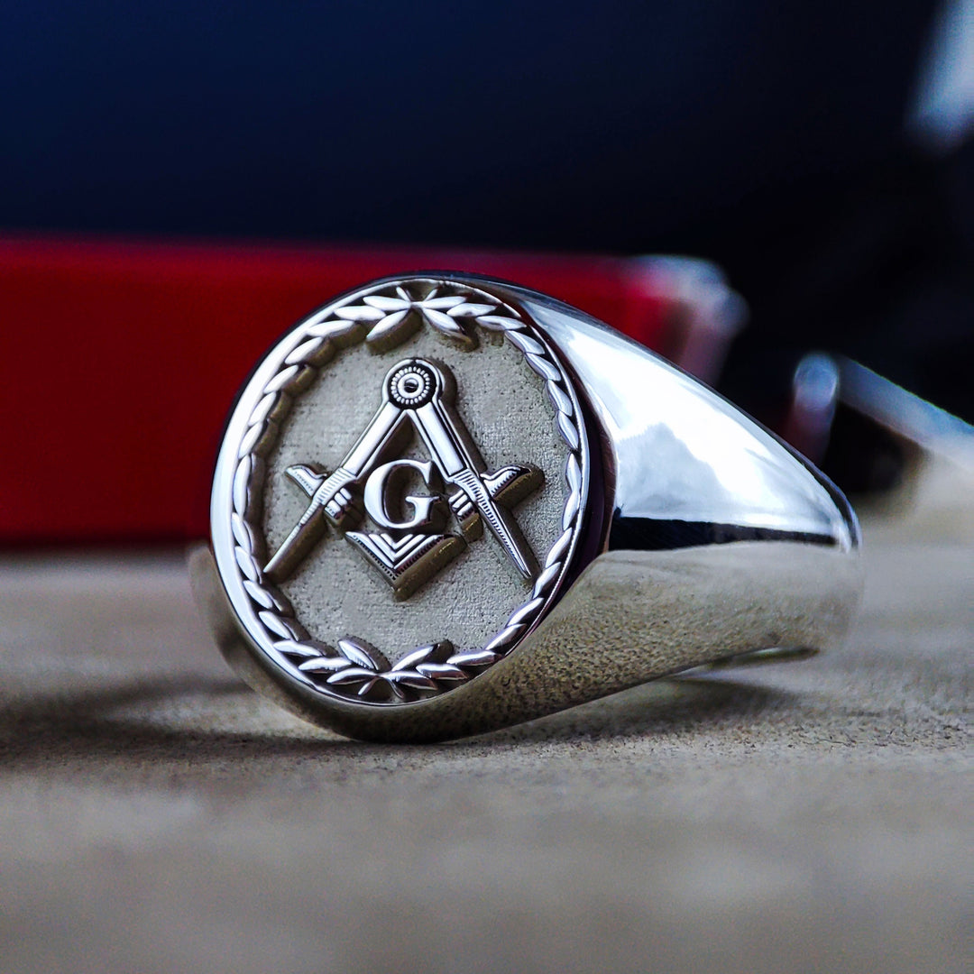 A vintage-inspired Masonic ring, crafted in sterling silver and adorned with a hand-engraved leaf pattern. The central Masonic emblem symbolizes knowledge and unity, making this ring a powerful representation of brotherhood. A bold and sophisticated piece, perfect as a lodge ring or a personal statement accessory.