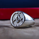 Load image into Gallery viewer, This elegant silver Masonic ring features a classic signet design with an engraved leaf pattern and the iconic Freemason emblem. A symbol of wisdom, fraternity, and enlightenment, this handcrafted ring is ideal for those who embrace Masonic traditions. A meaningful and stylish gift for members of the brotherhood.