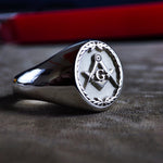 Load image into Gallery viewer, This handcrafted silver Masonic ring is adorned with a leaf motif, enhancing its vintage-inspired look. Featuring the engraved square and compass symbol, this Freemason ring is an elegant signet piece for men who honor the principles of the fraternity. A timeless and meaningful jewelry piece, designed for everyday wear or ceremonial occasions.