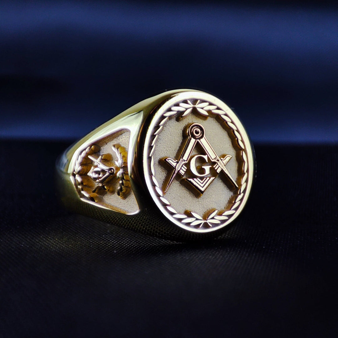 Personalized Masonic ring in gold plated finish, featuring ornate engravings and a classic Freemason symbol at the center. The detailed pattern around the band adds character, while custom text options make it unique. Perfect for Freemasons looking to celebrate their journey with elegance. A great gift for lodge members or a refined keepsake for personal expression. Timeless, bold, and symbolic jewelry crafted with precision and care.