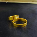 Load image into Gallery viewer, These minimalist gold-plated wedding bands are perfect for couples who prefer sleek and modern jewelry. Made with vermeil gold plating over sterling silver, these rings offer a refined and elegant design. Whether worn daily or on special occasions, this engagement ring set is a stunning symbol of love and commitment.
