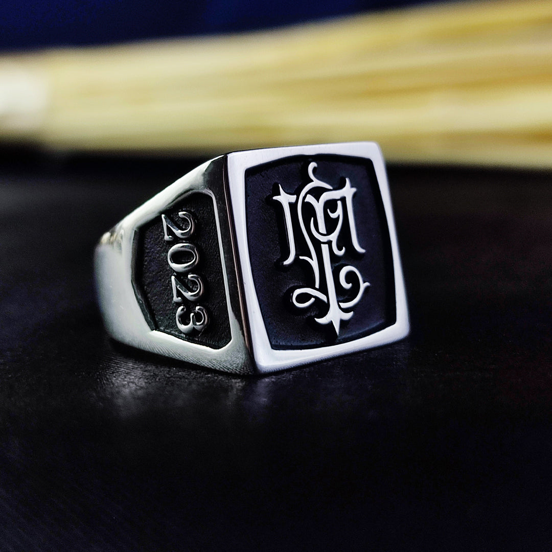A sophisticated silver monogram signet ring, crafted for those who appreciate personalized jewelry. Engraved with initials in a stylish square design, this ring is a lasting representation of individuality and legacy. Whether gifted to a loved one or chosen as a unique personal accessory, this elegant signet ring exudes refinement and sentimental value.