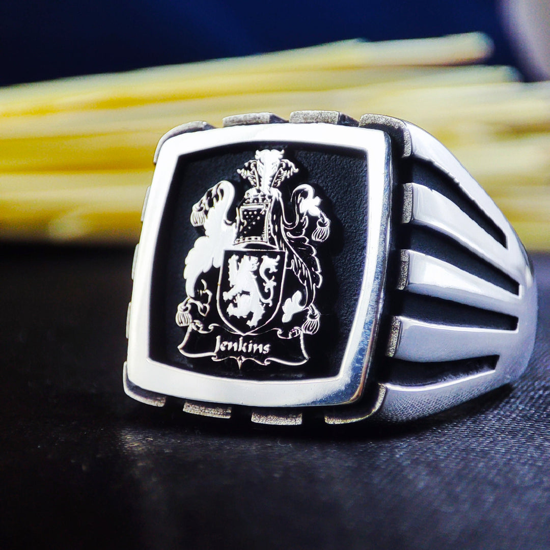 A timeless silver signet ring designed for men, featuring an engraved family crest or logo. This square-shaped ring is a symbol of nobility and legacy, crafted with precision for durability and elegance. Ideal for those who appreciate meaningful jewelry, this heirloom-quality ring is perfect for marking special occasions, making it a unique and cherished keepsake.