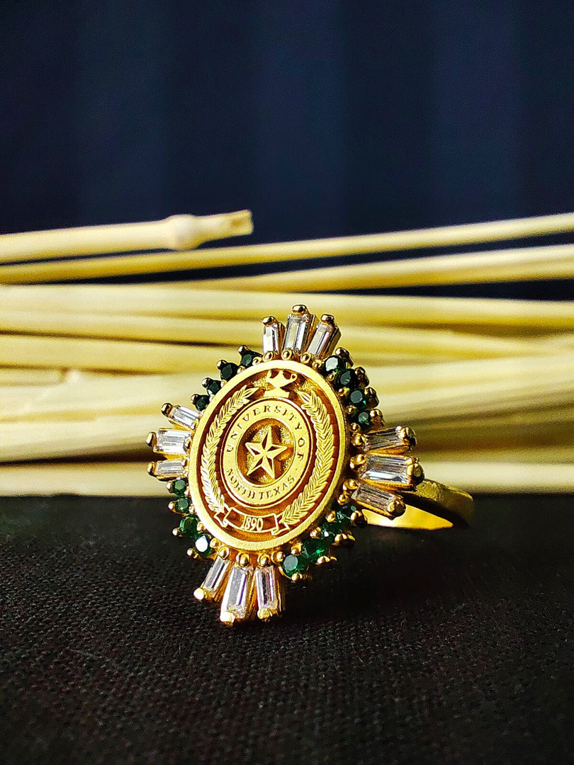 This custom gold vermeil graduation ring is a stylish and meaningful accessory for university students and alumni. The baguette-cut stone adds a touch of elegance, making it a sophisticated class signet ring. Designed for women, this personalized piece is a unique way to commemorate academic success. A thoughtful and elegant gift for any graduate, celebrating milestones in a refined manner.