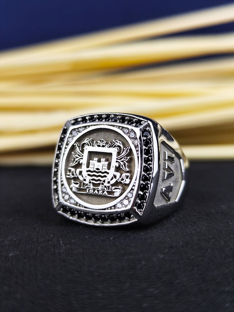 This family crest signet ring is an exceptional piece of heraldic jewelry, crafted in silver with a detailed engraving of a custom coat of arms. The striking black stone enhances its regal appearance, making it a bold and elegant choice for men. A meaningful and timeless ring, ideal for heritage lovers and those who appreciate personalized jewelry.
