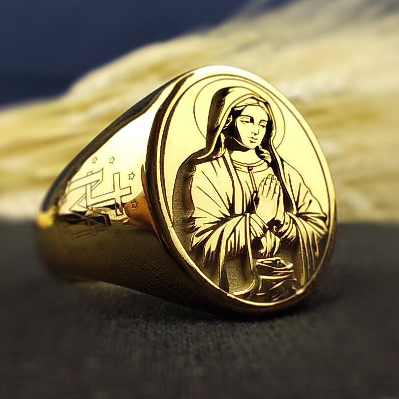 Gold Virgin Mary ring featuring a beautiful religious symbol, perfect for Catholic believers.