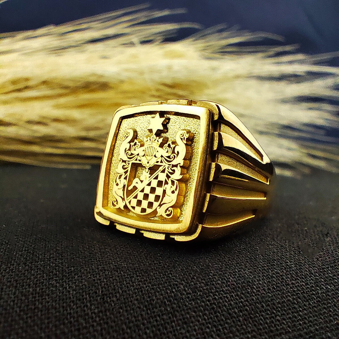 This handcrafted square gold-plated signet ring is a timeless tribute to family heritage. Featuring a precision-engraved coat of arms or custom emblem, it is a sophisticated gift for men who take pride in their ancestry. Ideal for marking milestones, this noble and regal ring embodies history and tradition, offering a blend of modern craftsmanship and vintage elegance.