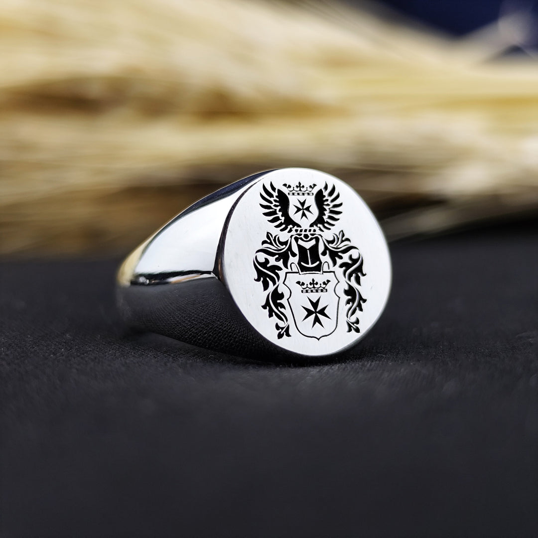 This custom engraved family crest ring is a timeless piece of heritage jewelry, featuring a recessed coat of arms design. Crafted in high-quality metal, this round signet ring is perfect for men who appreciate tradition and noble ancestry. A meaningful heirloom, it can be customized with a family emblem or initials, making it an ideal gift for special occasions such as anniversaries, birthdays, or graduations.