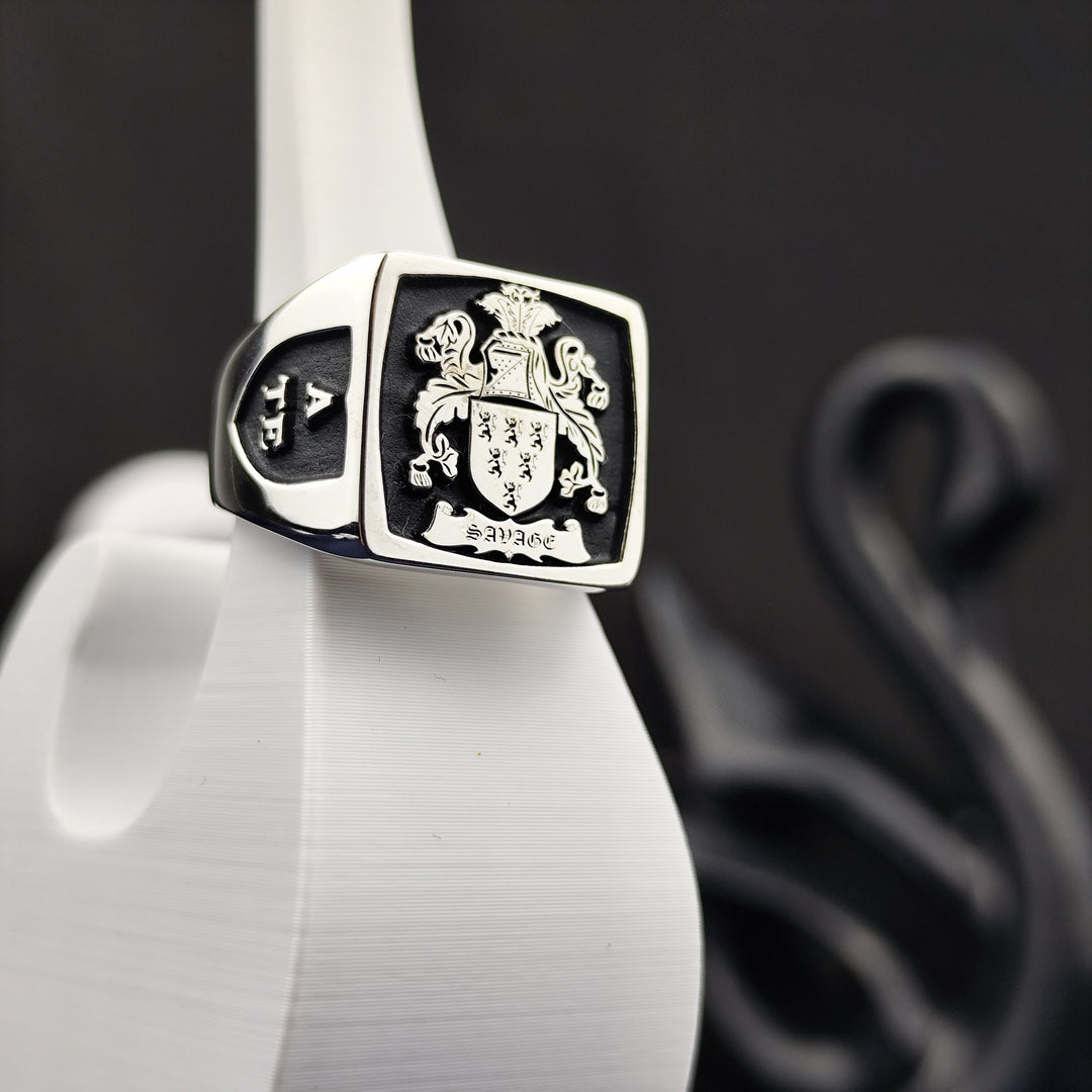 This custom silver heraldic signet ring features a recessed engraving of a coat of arms, enhanced with black enamel for a bold and elegant look. A unique family crest ring for those who cherish history and legacy, this square design offers a regal and distinguished presence. Perfect as a keepsake, heirloom, or meaningful personalized gift.