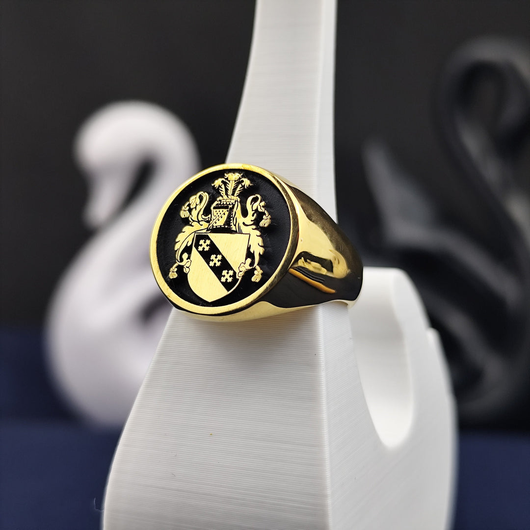 A refined and timeless gold-plated round signet ring, featuring an intricately engraved family crest. Perfect for men who value tradition, history, and nobility, this custom heraldic jewelry piece serves as a unique way to honor one’s lineage. Whether as a commemorative keepsake or a cherished heirloom, this ring is crafted for elegance and longevity.