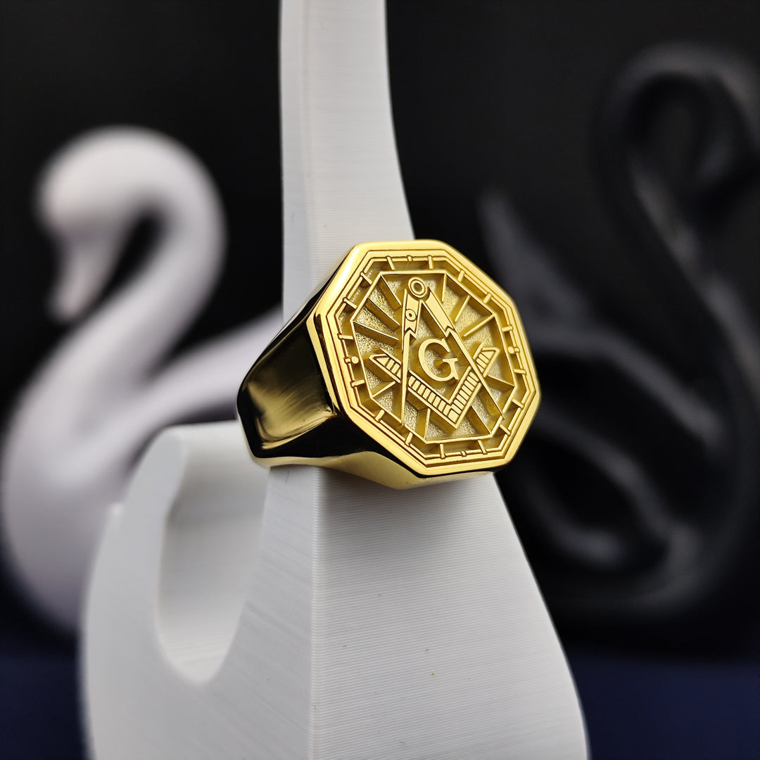 A bold and elegant octagonal Freemason signet ring, crafted in gold plating with a deep-engraved square and compass symbol. Designed to honor Masonic traditions, this lodge ring is perfect for those who value history and symbolism. Whether worn for formal occasions or daily wear, this custom Masonic jewelry piece embodies the timeless values of the fraternity.
