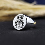 Load image into Gallery viewer, This personalized round signet ring is a sophisticated family heirloom, designed with a recessed coat of arms engraving. Crafted for durability and elegance, it represents strength, history, and personal legacy. Whether worn as a statement ring or gifted for a special occasion, this custom engraved crest ring is an exceptional piece of heritage jewelry.