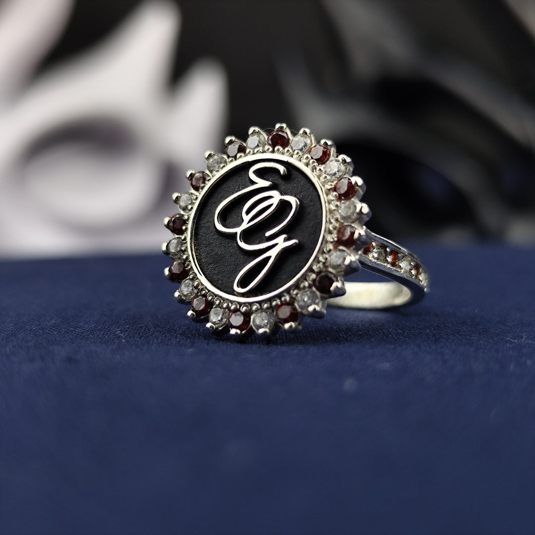 This personalized silver monogram ring is designed for women who love unique and elegant jewelry. Featuring two custom letters, a gemstone accent, and a sleek enamel finish, this ring is a sophisticated way to showcase your initials. Whether as a meaningful gift or a treasured accessory, this piece adds a touch of class to any jewelry collection.