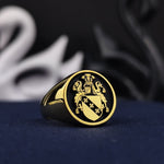 Load image into Gallery viewer, This antique-inspired gold-plated family crest ring is a stunning piece of heraldic jewelry, crafted with a personalized engraving of a coat of arms. The round signet design enhances its regal and historical aesthetic. A timeless gift for history enthusiasts, nobles, or those who appreciate the significance of their family emblem, this noble ring is a statement of legacy and sophistication.