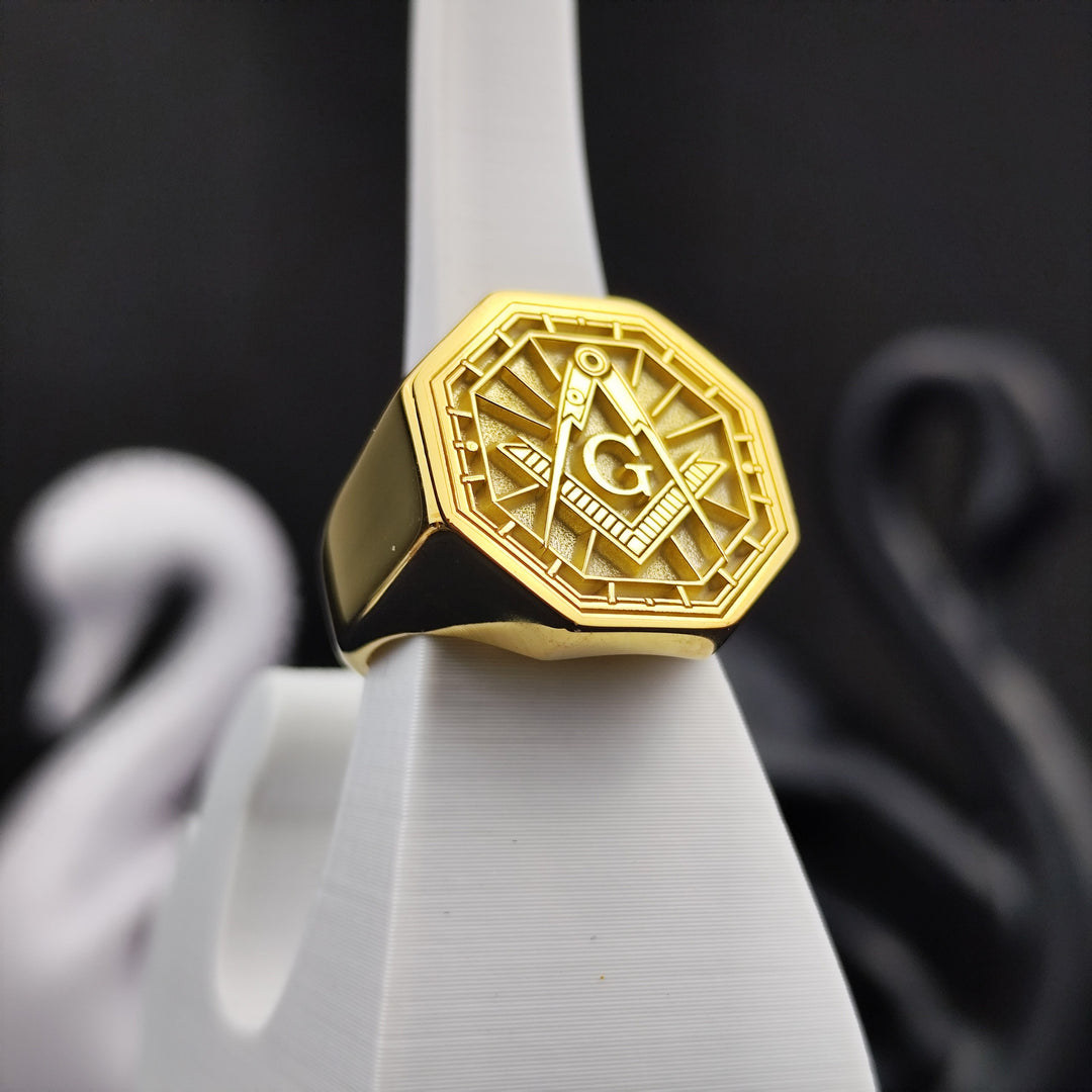 A high-quality octagonal Masonic signet ring, gold-plated for a bold and elegant finish. Featuring a detailed engraving of the square and compass, this ring is a representation of dedication to Freemasonry. Ideal for everyday wear or formal lodge events, this durable and symbolic piece is a distinguished addition to any Mason’s collection.