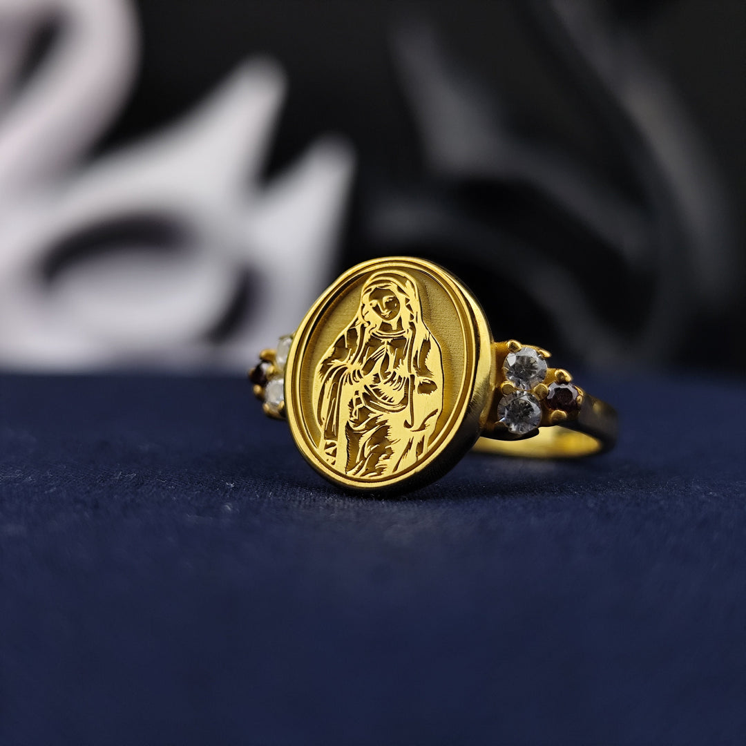 This elegant gold-plated signet ring features an intricately detailed Virgin Mary engraving with a delicate gemstone accent. A timeless Catholic jewelry piece designed for women who appreciate faith-based accessories. Perfect as a meaningful keepsake, this beautiful ring makes a thoughtful gift for religious occasions, serving as a symbol of devotion and divine guidance.