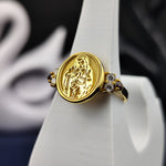 Load image into Gallery viewer, A graceful and feminine religious ring featuring a beautifully crafted Virgin Mary design with a gemstone accent. Made with gold plating, this Catholic jewelry piece is perfect for women who cherish their faith. A timeless and elegant accessory, ideal for gifting on religious occasions or as a daily symbol of devotion and protection.