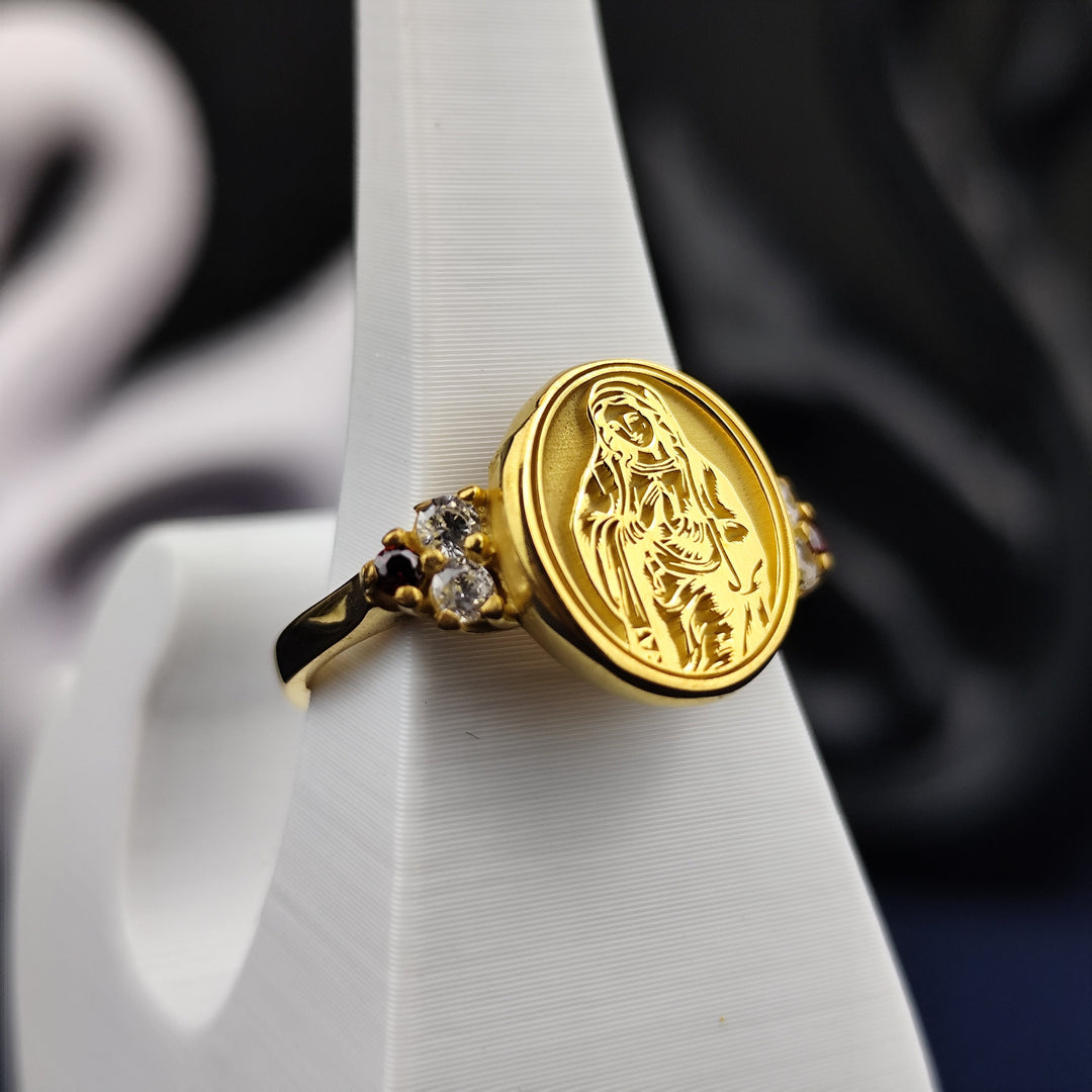 A stunning women's religious ring, crafted in gold plating and adorned with a sparkling gemstone. This Virgin Mary ring embodies grace and devotion, making it a perfect faith-inspired jewelry piece. Whether worn as a statement of belief or as an elegant accessory, this ring is a meaningful gift for those who honor the Blessed Mother and her spiritual presence.