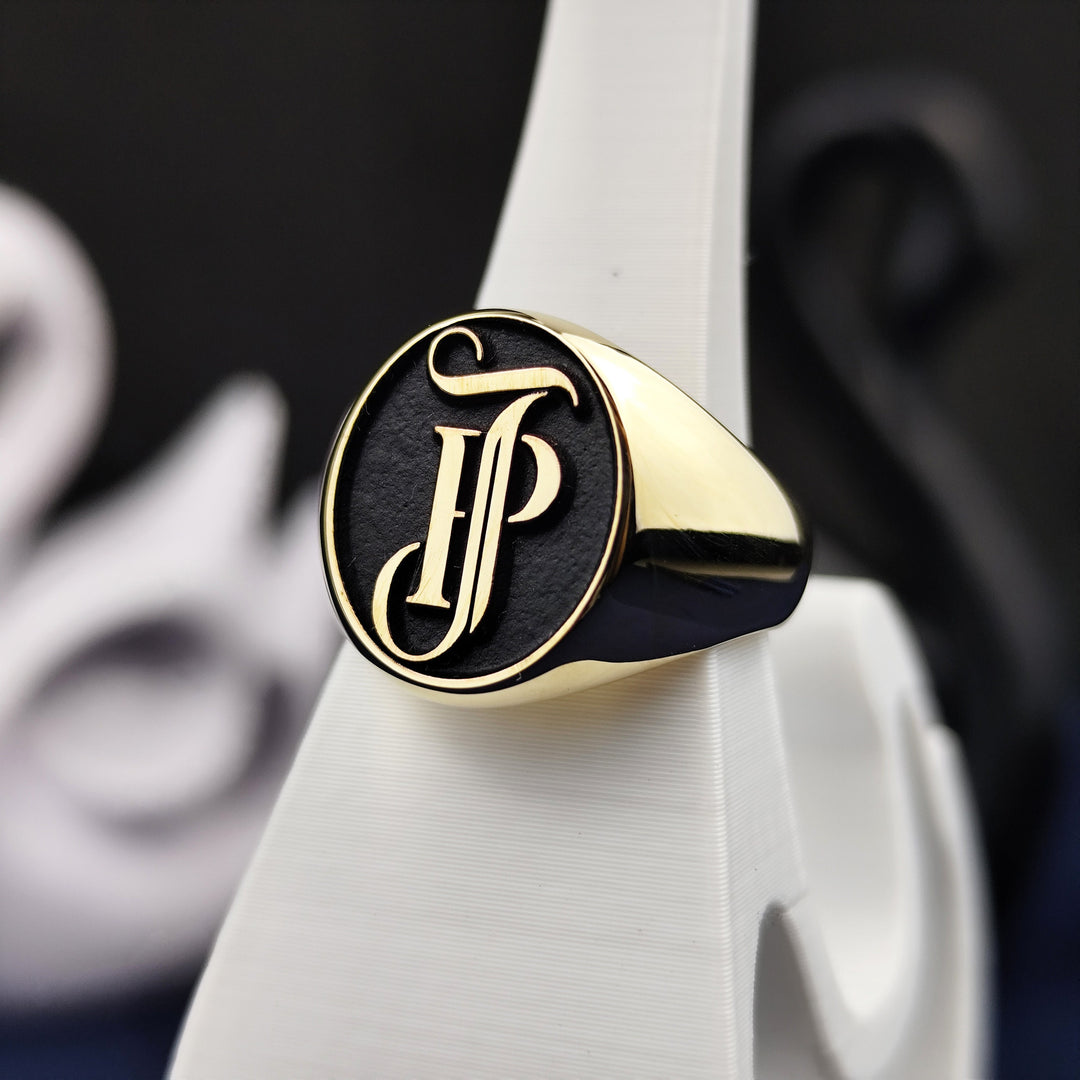 This 14K gold monogram ring features custom-engraved initials in a traditional seal design. With exquisite detailing and a polished finish, it's a meaningful gift or keepsake that combines elegance, legacy, and craftsmanship. Ideal for those who appreciate bold gold jewelry with a personal connection to name and family.