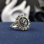 Load image into Gallery viewer, This stunning silver monogram ring is designed with two custom initials, making it a perfect name or surname ring. The intricate engraving, paired with a gemstone accent and an enamel-coated finish, creates a luxurious look. Whether worn daily or gifted for a special occasion, this elegant signet ring is a timeless representation of personal identity.