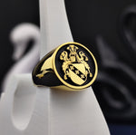 Load image into Gallery viewer, This round gold-plated family crest ring is a symbol of heritage and nobility, featuring a custom-engraved coat of arms. Designed as a sophisticated and meaningful heirloom, this heraldic signet ring blends traditional elegance with modern craftsmanship. A perfect gift for those who cherish family legacy, it makes an excellent addition to any jewelry collection, serving as a refined and stylish statement piece.
