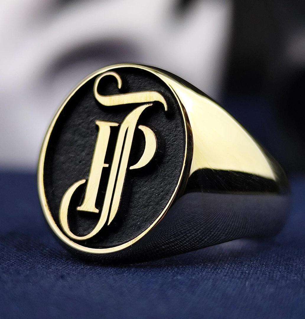 This personalized 14K gold ring captures your initials in a stunning monogram seal design. Whether worn as a family heirloom or statement ring, its intricate engraving and polished gold surface reflect elegance, identity, and craftsmanship. A luxurious piece ideal for daily wear or meaningful celebrations.