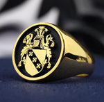 Load image into Gallery viewer, A bold and elegant round signet ring, crafted in gold plating and engraved with a detailed family crest. This custom heraldic ring is a unique representation of personal heritage and historical tradition. Whether worn as a statement accessory or passed down as an heirloom, this coat of arms ring is an exquisite piece for men who appreciate legacy, making it a distinguished and timeless jewelry choice.