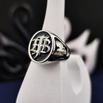 Load image into Gallery viewer, Silver men’s signet ring with personalized monogram, offering a timeless look. Perfect for special events or daily wear, it’s a unique piece that reflects one’s identity.