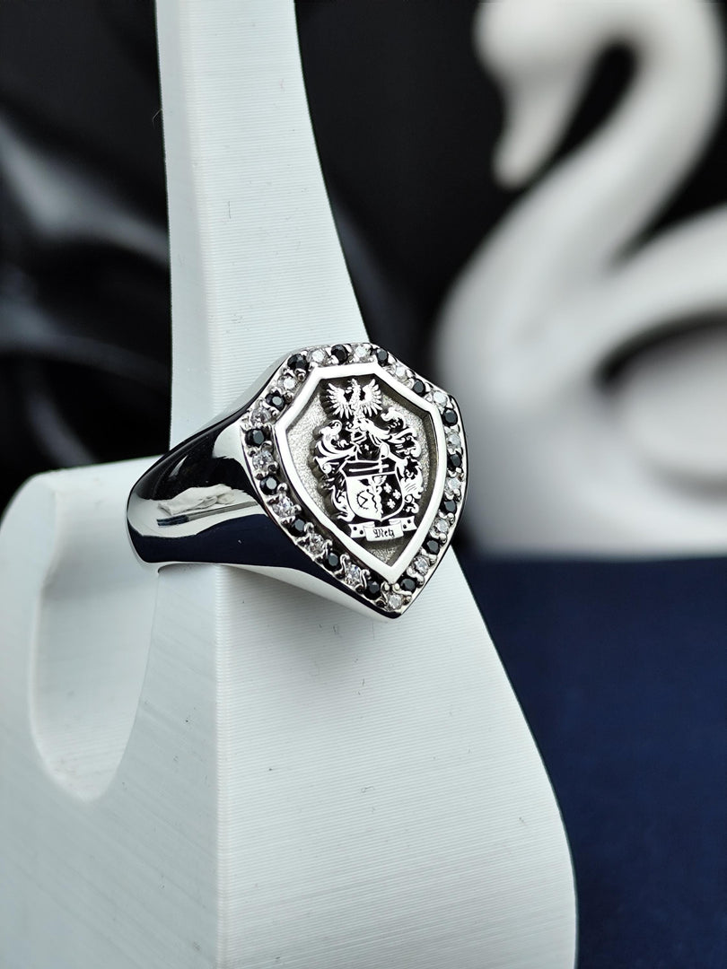 A refined and luxurious heraldic ring, this shield-shaped family crest signet features black and white gemstones, symbolizing strength and balance. Crafted with meticulous detail, it is a timeless statement piece for those who honor their lineage. A perfect custom heirloom ring that makes an unforgettable gift for those who appreciate history and regal jewelry.