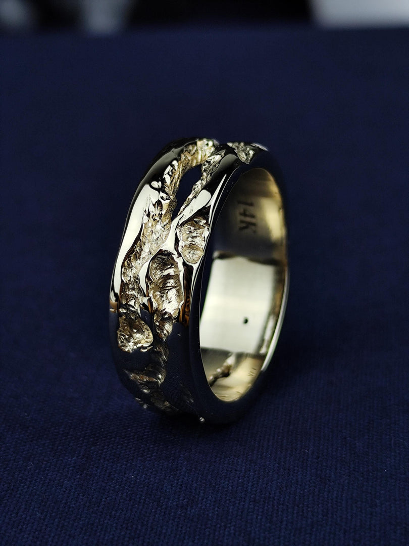 A refined yet rustic 14K gold ring, designed with a rough-textured surface for an artisanal, natural feel. Perfect as a wedding band or a stacking ring, this handcrafted solid gold piece is a blend of minimalism and organic beauty. A unique jewelry piece for men and women who appreciate raw, earthy elegance in their accessories.