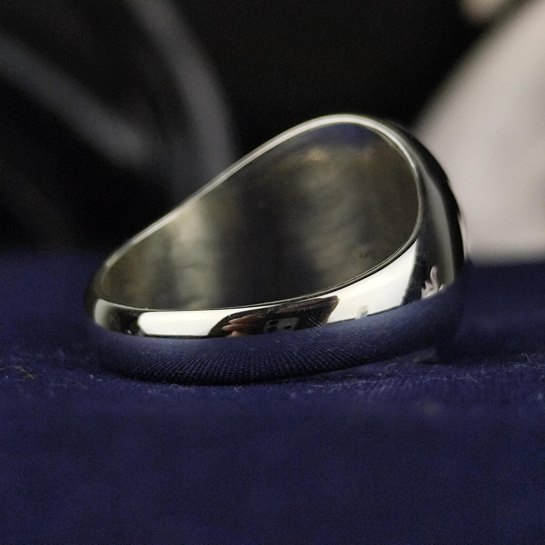 A timeless custom silver family crest ring with a round signet face, featuring deep engraving and black enamel accents. This heraldic ring is an elegant representation of lineage, making it a unique and personal heirloom. Crafted for durability and style, this noble signet ring is a perfect accessory for history enthusiasts and those who appreciate personalized jewelry.