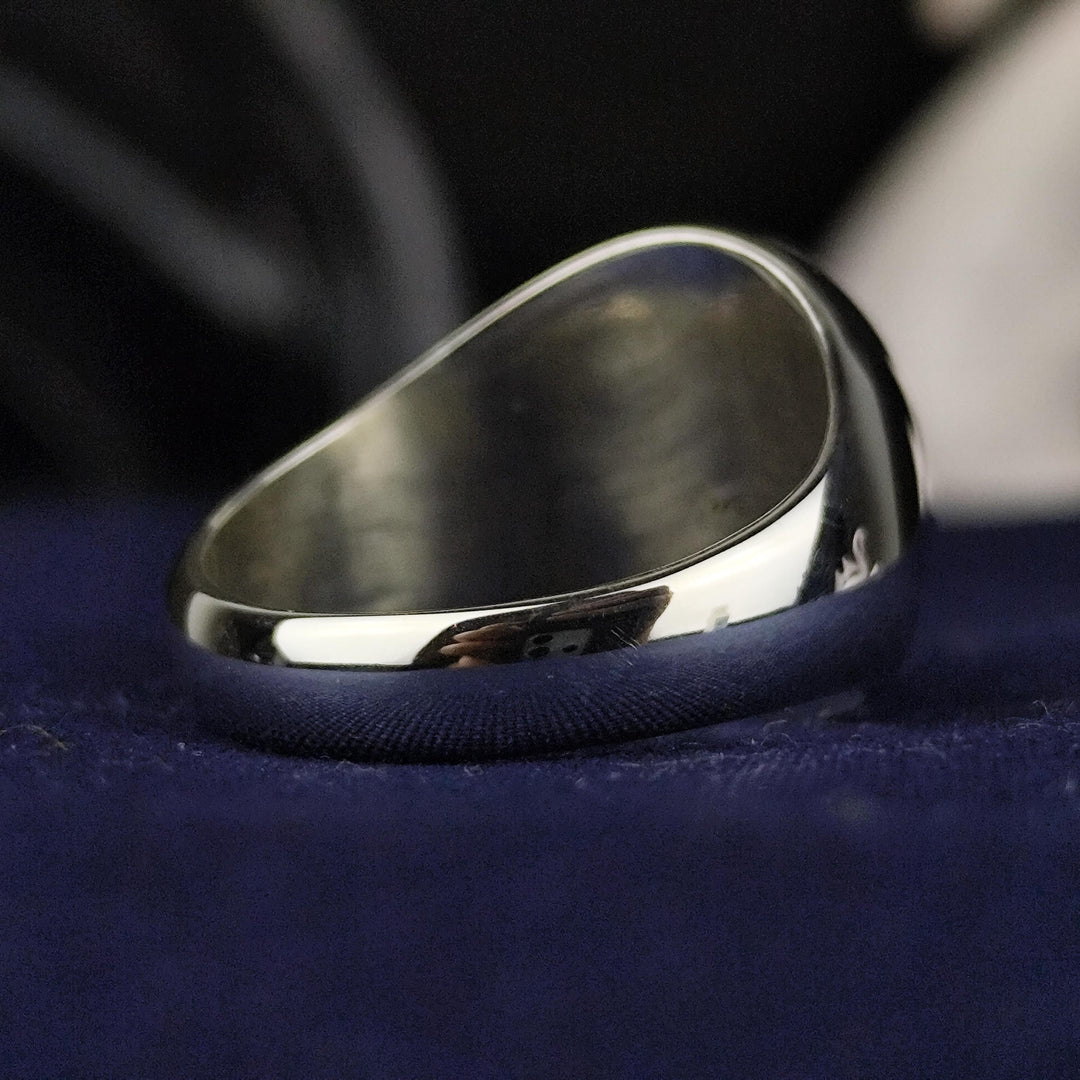 A timeless custom silver family crest ring with a round signet face, featuring deep engraving and black enamel accents. This heraldic ring is an elegant representation of lineage, making it a unique and personal heirloom. Crafted for durability and style, this noble signet ring is a perfect accessory for history enthusiasts and those who appreciate personalized jewelry.