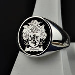 Load image into Gallery viewer, This handcrafted silver signet ring features a round shape with a custom-engraved family crest, enhanced by bold black enamel. Designed as a historical tribute to personal heritage, this unique piece makes a remarkable heirloom. A meaningful gift for those who appreciate history, nobility, and timeless craftsmanship, this ring is perfect for formal occasions or everyday wear.