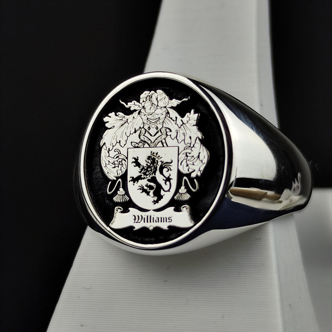 This handcrafted silver signet ring features a round shape with a custom-engraved family crest, enhanced by bold black enamel. Designed as a historical tribute to personal heritage, this unique piece makes a remarkable heirloom. A meaningful gift for those who appreciate history, nobility, and timeless craftsmanship, this ring is perfect for formal occasions or everyday wear.