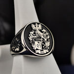 Load image into Gallery viewer, Silver heirloom ring with an engraved family crest, perfect for celebrating ancestry. A thoughtful gift for those who value tradition.