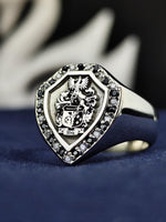 Load image into Gallery viewer, A striking shield signet ring featuring an engraved family crest, adorned with black and white stones for a regal appearance. This custom coat of arms ring is crafted in fine detail, making it an exceptional heritage jewelry piece. Whether worn as a symbol of ancestry or given as a meaningful gift, this heraldic ring is a powerful representation of strength and tradition.