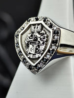 Load image into Gallery viewer, This custom shield-shaped family crest ring is an elegant blend of history and craftsmanship. Featuring an engraved coat of arms with black and white stones, this ring is designed to showcase personal heritage. A regal and refined accessory, perfect as a distinguished heirloom or a meaningful symbol of lineage, crafted for those who value tradition.