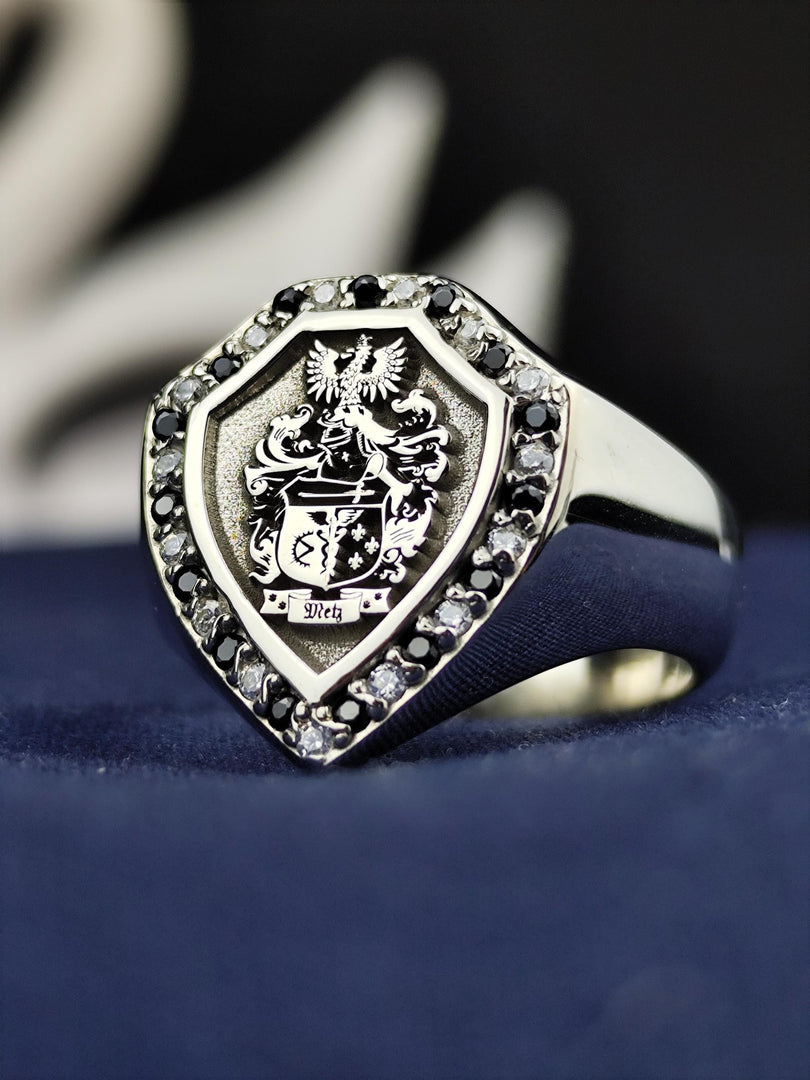 This noble shield-shaped signet ring is custom-engraved with a family crest and set with contrasting black and white stones. Designed for those who cherish history and heritage, this heraldic ring serves as a sophisticated heirloom. Whether gifted for a milestone occasion or worn as a personal emblem, this unique jewelry piece captures the essence of nobility.
