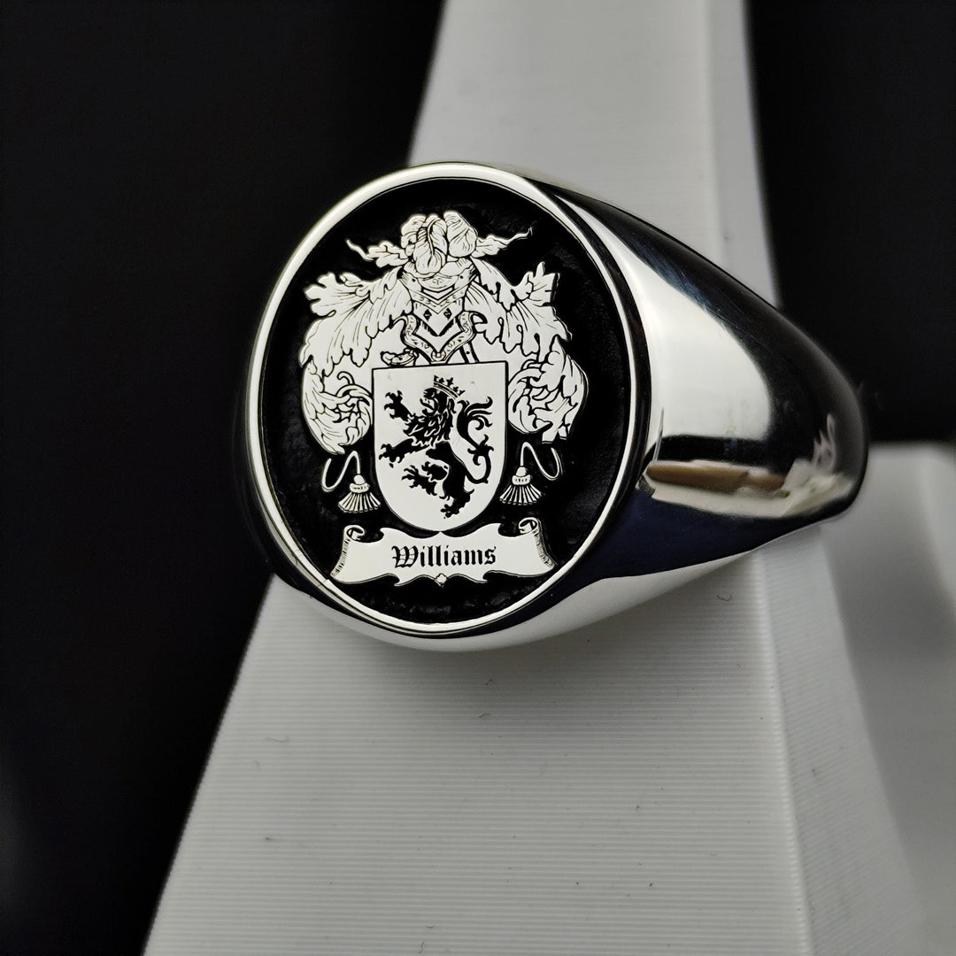 This vintage-style silver signet ring features a round face engraved with a family crest, accentuated with black enamel for a striking effect. A timeless symbol of noble heritage, this custom coat of arms ring is designed for those who appreciate historical significance and fine craftsmanship. A refined and meaningful addition to any jewelry collection.