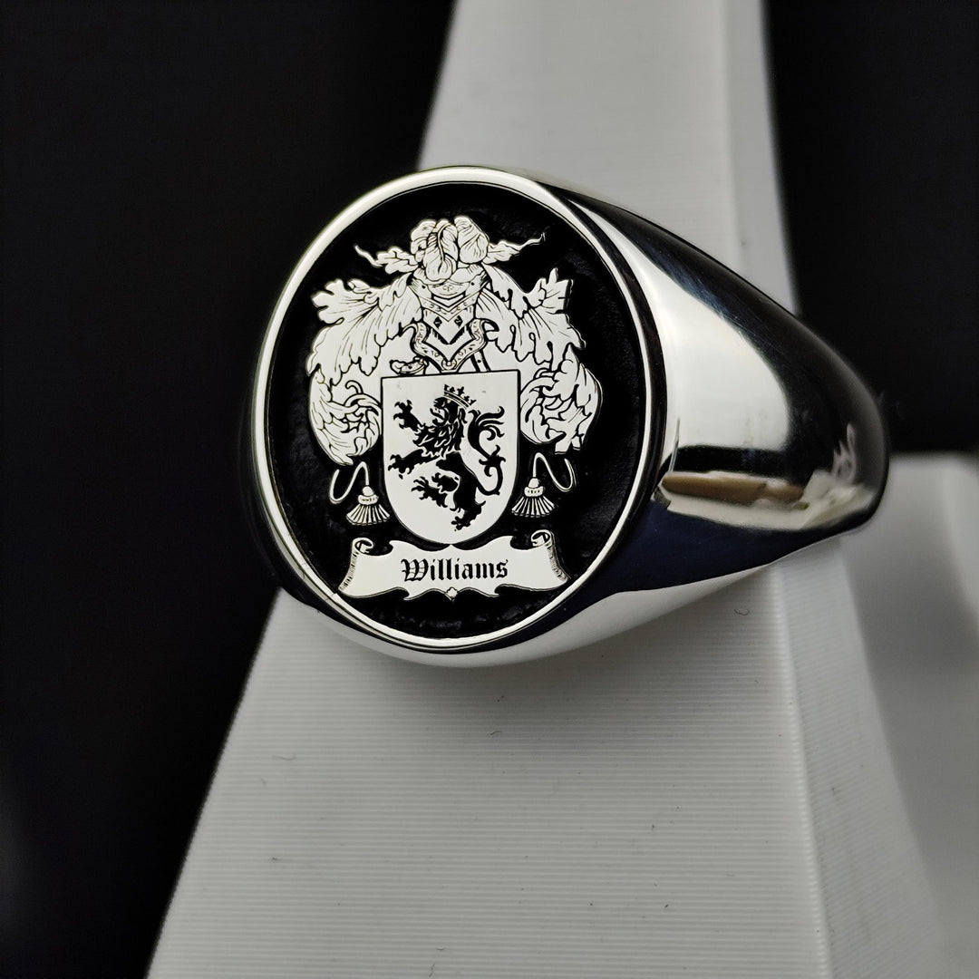 This vintage-style silver signet ring features a round face engraved with a family crest, accentuated with black enamel for a striking effect. A timeless symbol of noble heritage, this custom coat of arms ring is designed for those who appreciate historical significance and fine craftsmanship. A refined and meaningful addition to any jewelry collection.