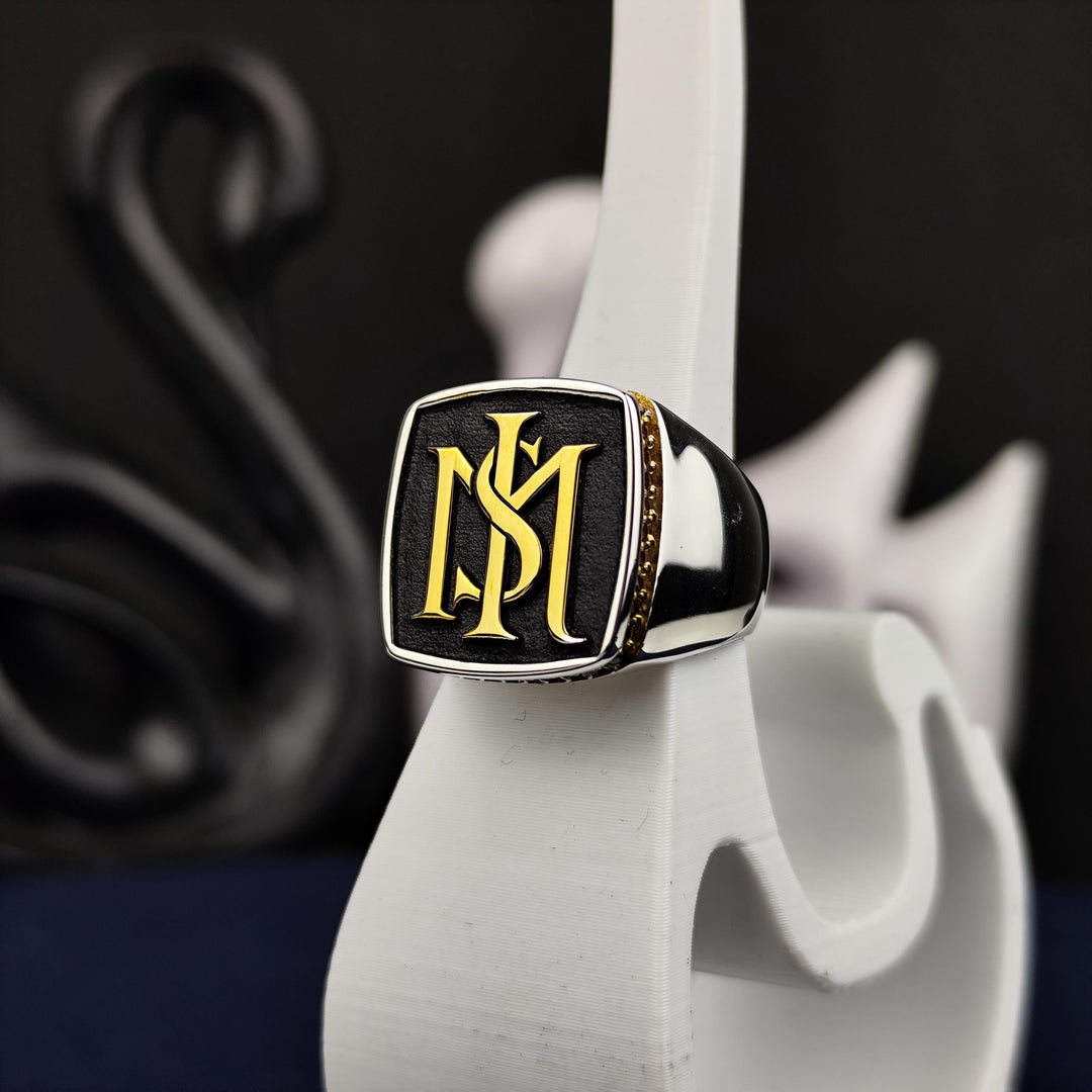 Monogrammed silver ring for men with a central stone, offering a sophisticated design perfect for daily wear or commemorating special moments in style.