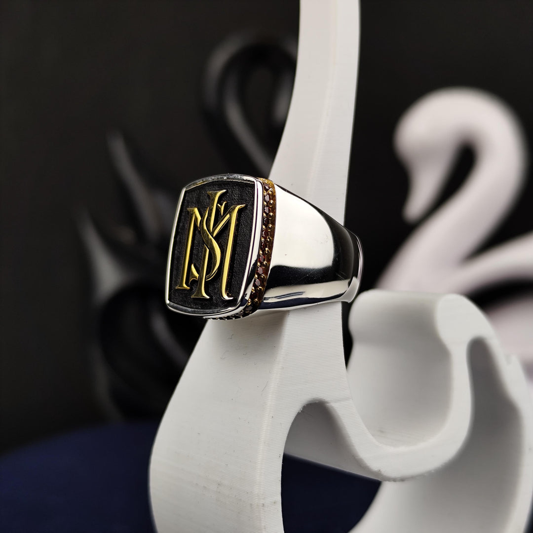 Elegant men’s silver signet ring with a stone and two initials, blending modern design with traditional craftsmanship. Perfect for those seeking meaningful, custom jewelry.