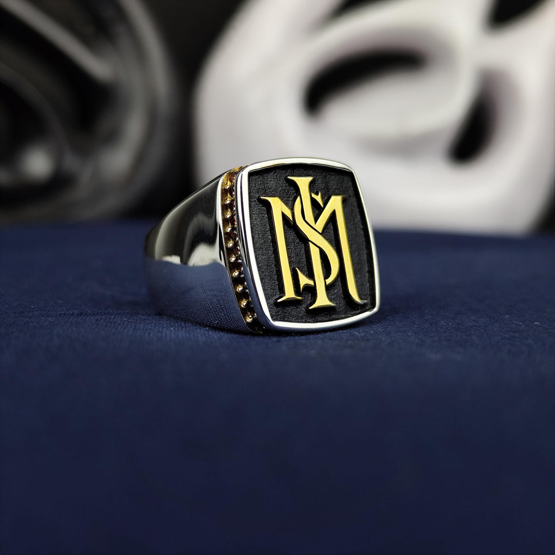 Custom men’s silver ring with a central stone and two initials, blending classic design with personal significance. A perfect choice for special occasions or as a thoughtful gift for someone important.