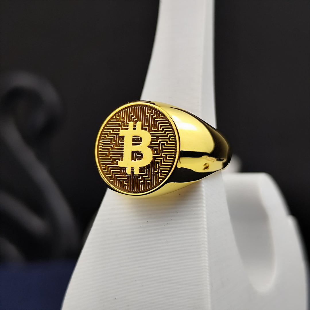 Sophisticated gold Bitcoin ring featuring a detailed cryptocurrency emblem. A stylish way to showcase blockchain pride and financial innovation.