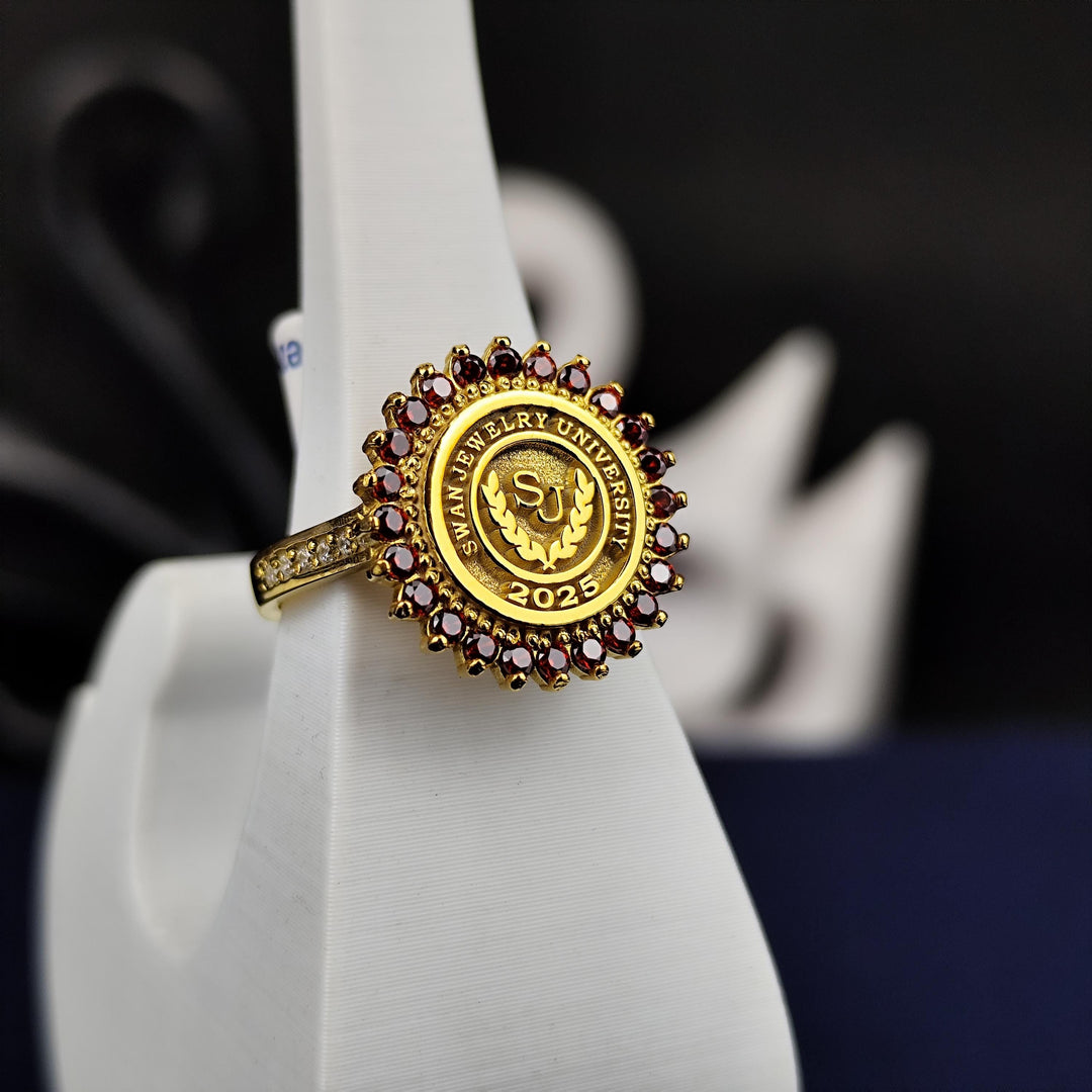 Women’s round gold-plated university ring featuring a vibrant red stone, crafted for elegance and style. This ring is a perfect gift for graduation or as a meaningful keepsake for academic achievements.