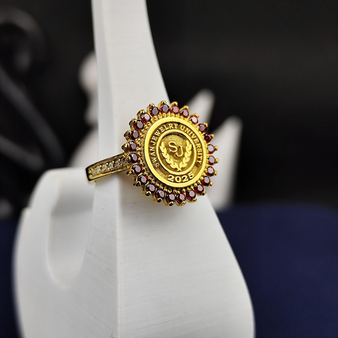 Custom women’s college ring with a bold red stone, crafted in a round gold-plated design. This elegant accessory celebrates milestones with sophistication.