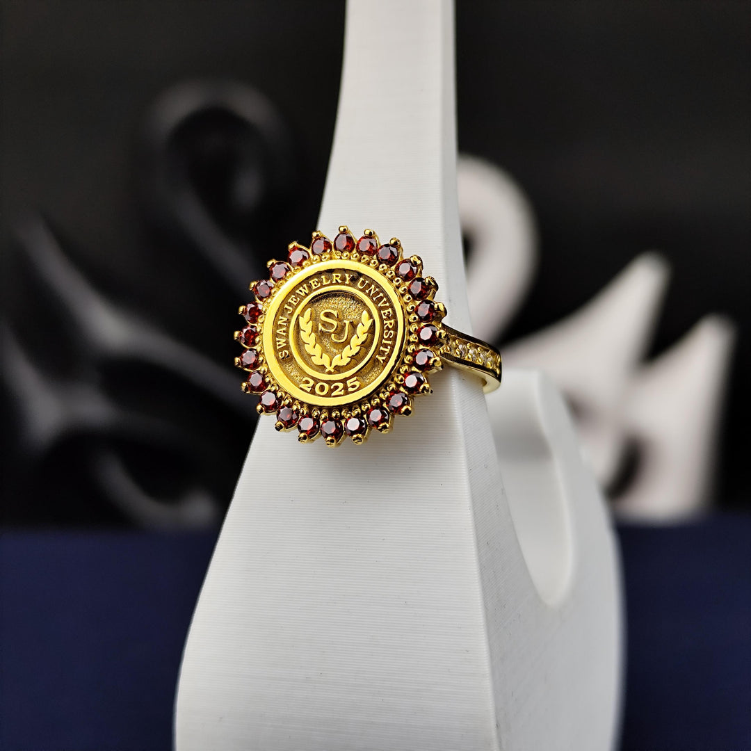 Gold-plated university ring for women, featuring a round design with a vibrant red stone. Perfect for marking academic pride and success.